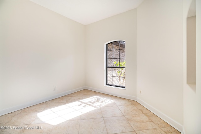 spare room featuring light tile patterned flooring