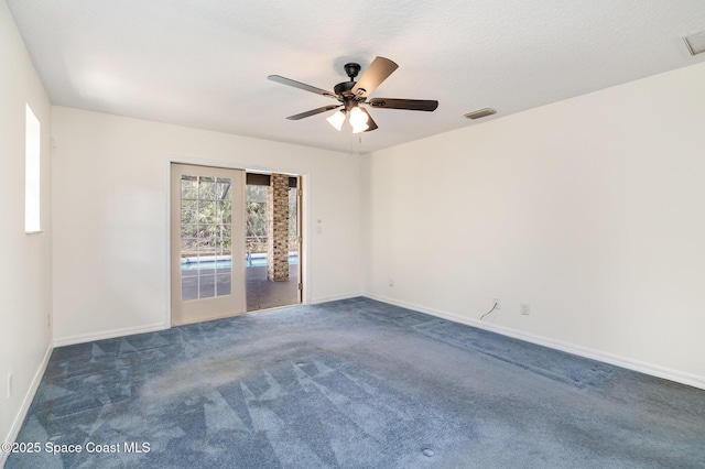 unfurnished room featuring ceiling fan and dark carpet