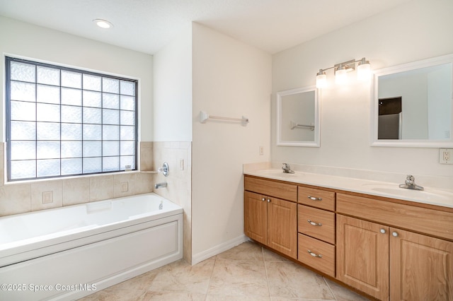 bathroom with tile patterned floors, vanity, and a bath