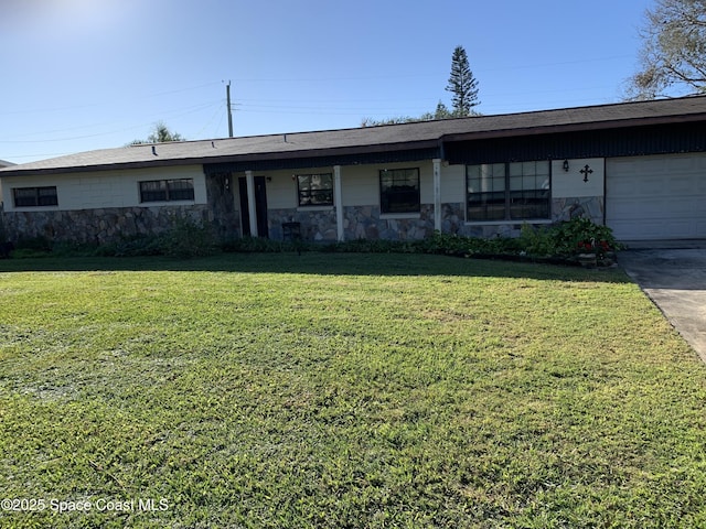 single story home featuring a garage and a front lawn