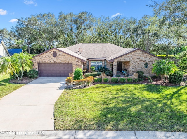 view of front of property with a front yard and a garage