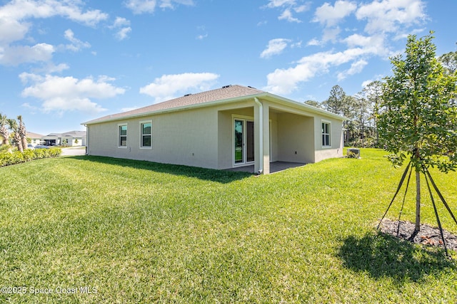 rear view of property featuring a yard