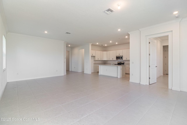 unfurnished living room with light tile patterned floors and crown molding