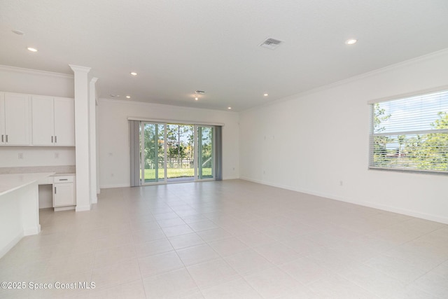 unfurnished living room with light tile patterned floors, built in desk, and ornamental molding