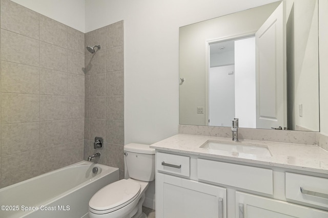 full bathroom featuring toilet, vanity, and tiled shower / bath