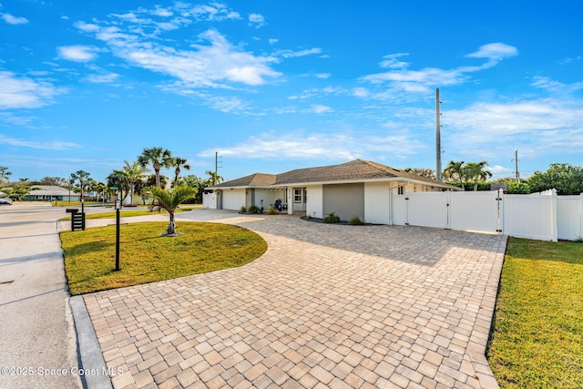 ranch-style house with a front yard and a garage