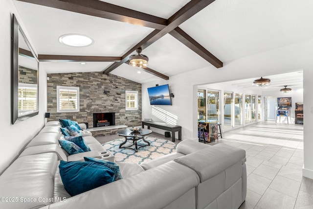 tiled living room with ceiling fan, a stone fireplace, and lofted ceiling with beams