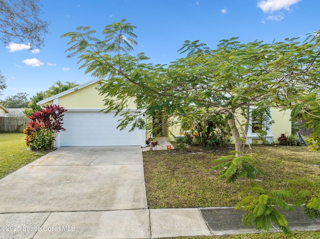 obstructed view of property with a garage and a front lawn