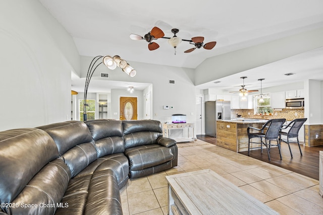 tiled living room with vaulted ceiling