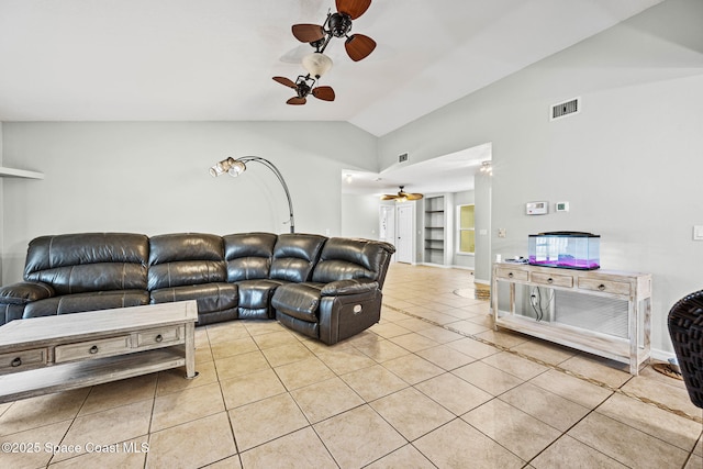 tiled living room with ceiling fan and vaulted ceiling