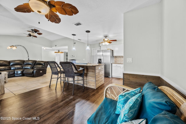 living room featuring lofted ceiling and wood-type flooring