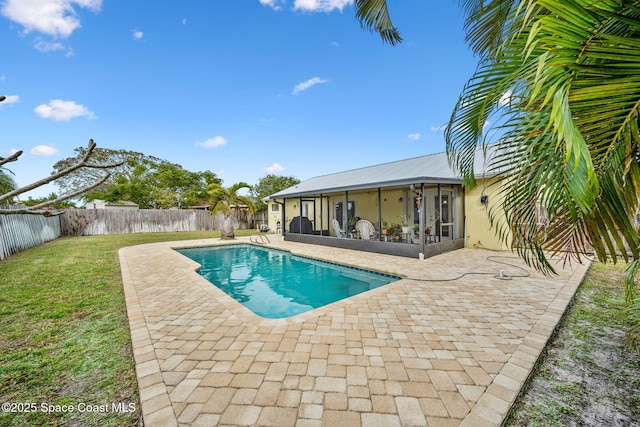 view of swimming pool with a yard, a sunroom, and a patio area