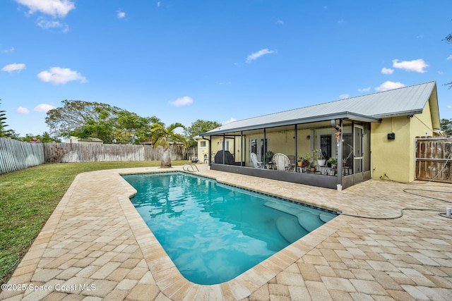 view of swimming pool featuring a patio area and a sunroom