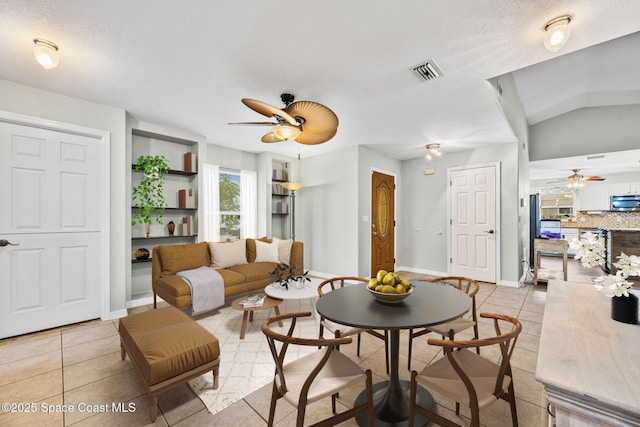 living room with a textured ceiling and light tile patterned flooring