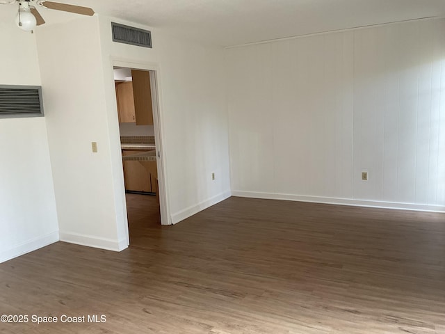 spare room featuring dark hardwood / wood-style floors and ceiling fan