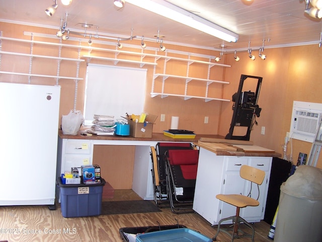 basement featuring white fridge and a wall mounted AC