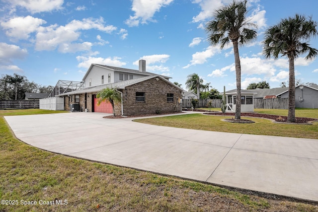 view of front of house with a front yard and a sunroom