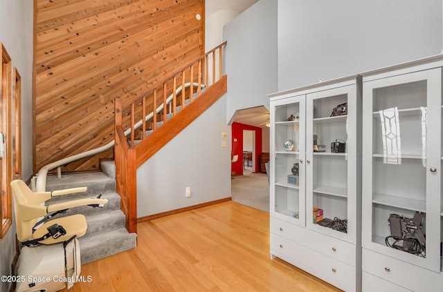 stairs with hardwood / wood-style flooring and built in features