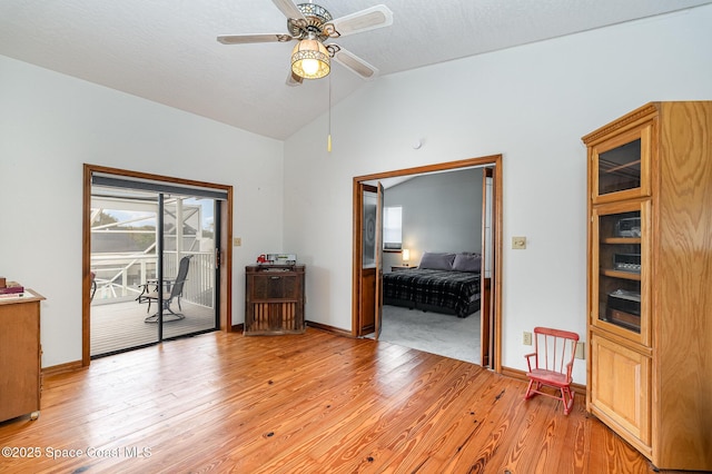 empty room featuring light wood-type flooring, ceiling fan, and lofted ceiling