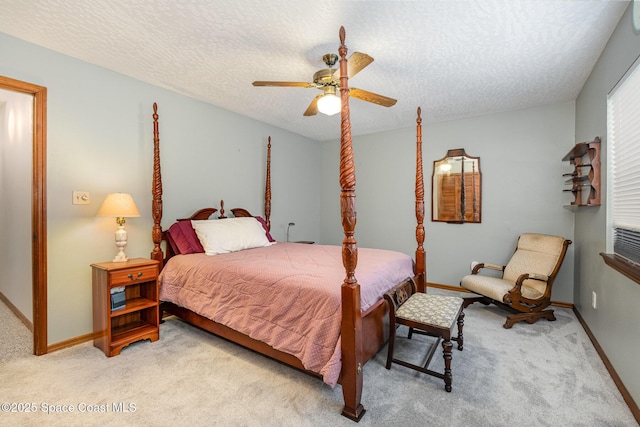 carpeted bedroom featuring a textured ceiling and ceiling fan