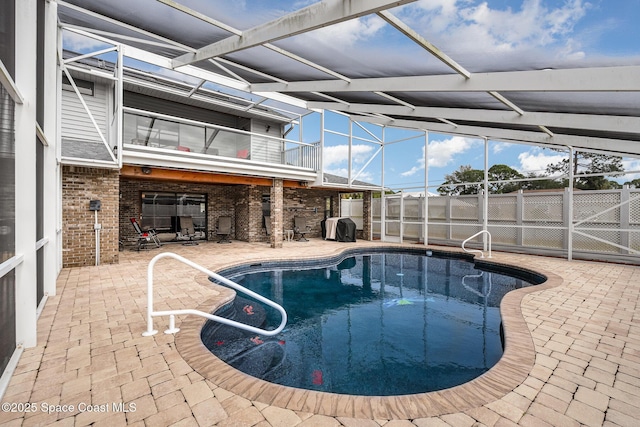 view of pool with a lanai, a patio area, and area for grilling