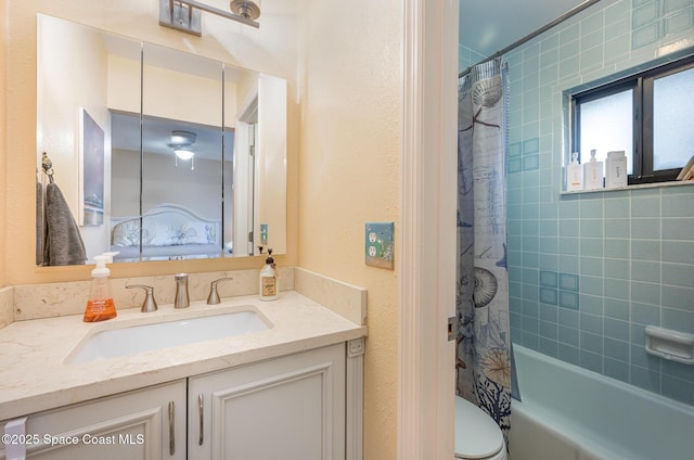 bathroom featuring vanity and shower / bathtub combination with curtain