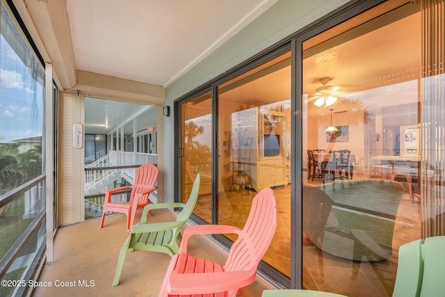 sunroom featuring ceiling fan