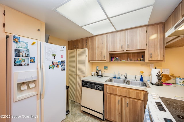 kitchen with white appliances, sink, and exhaust hood