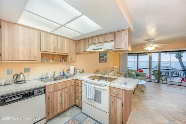 kitchen featuring kitchen peninsula, white appliances, ceiling fan, sink, and light brown cabinets