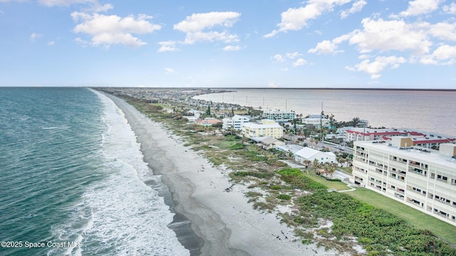 birds eye view of property featuring a water view and a view of the beach