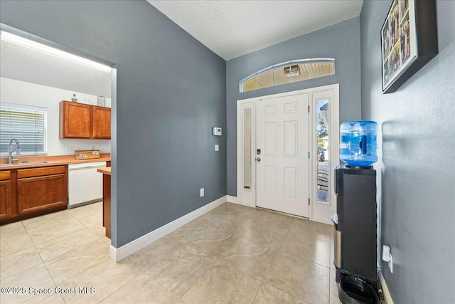 entrance foyer featuring sink and a textured ceiling