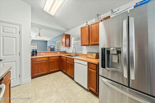 kitchen with stainless steel refrigerator with ice dispenser, sink, dishwasher, a chandelier, and lofted ceiling