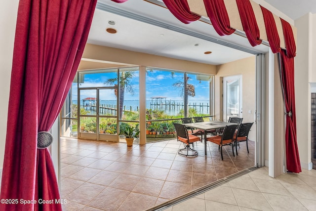 tiled dining space featuring a water view