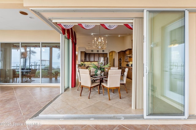 dining area featuring an inviting chandelier and tile patterned floors