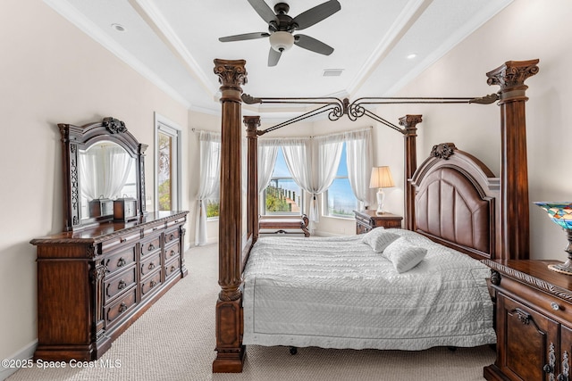 carpeted bedroom featuring ceiling fan, ornamental molding, and a tray ceiling