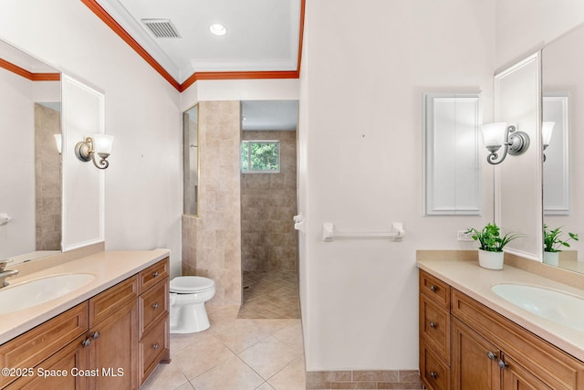 bathroom with tiled shower, ornamental molding, tile patterned flooring, and vanity