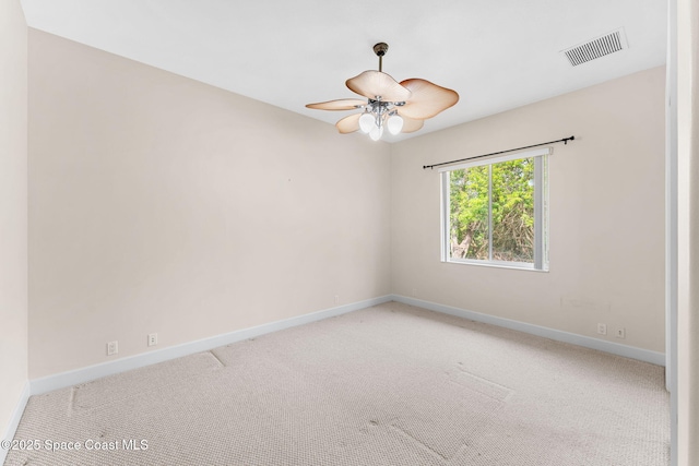 carpeted spare room with ceiling fan