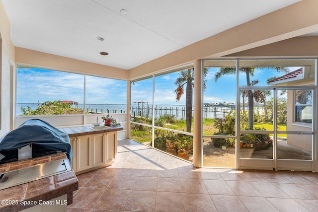 sunroom / solarium with a water view