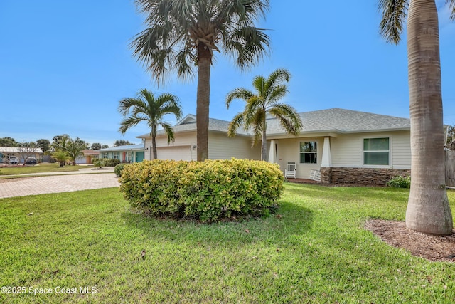 view of front of property with a front lawn and a garage