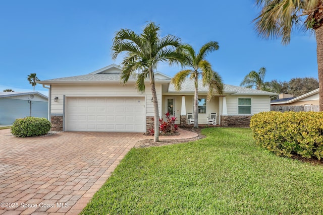 ranch-style home with a garage and a front yard