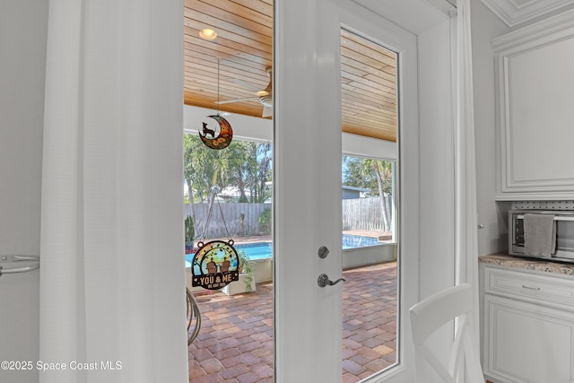 doorway with wooden ceiling