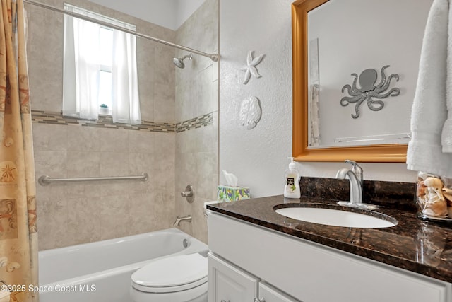 full bathroom featuring toilet, vanity, and shower / tub combo with curtain