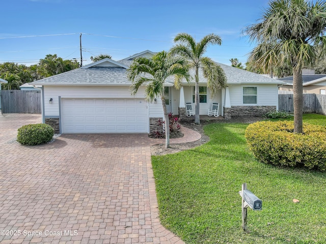 single story home featuring a front yard and a garage