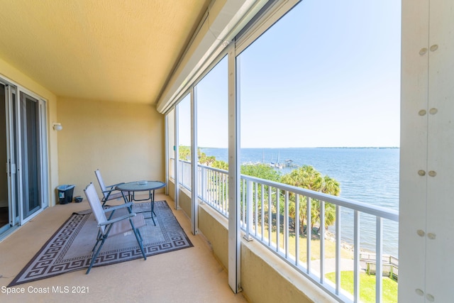 sunroom / solarium with a water view