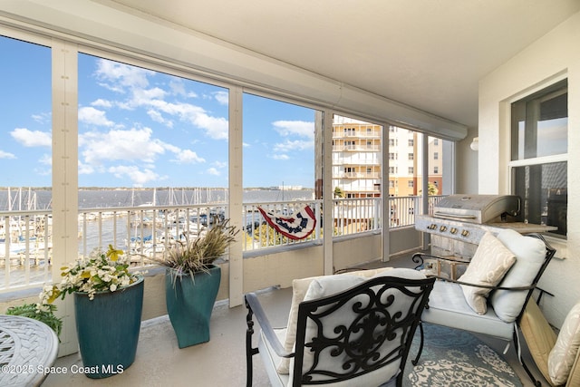 sunroom / solarium with a water view