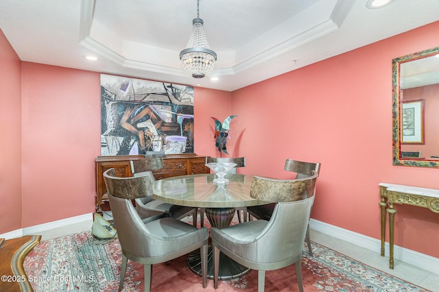 dining space with a tray ceiling, crown molding, a notable chandelier, and tile patterned flooring