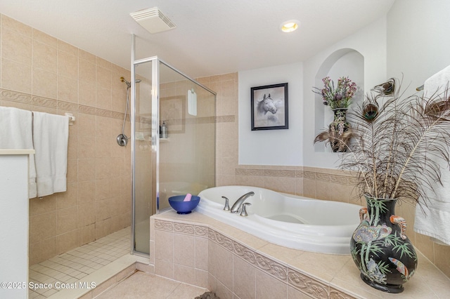 bathroom featuring tile patterned floors and shower with separate bathtub