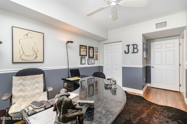 home office with ceiling fan and hardwood / wood-style flooring