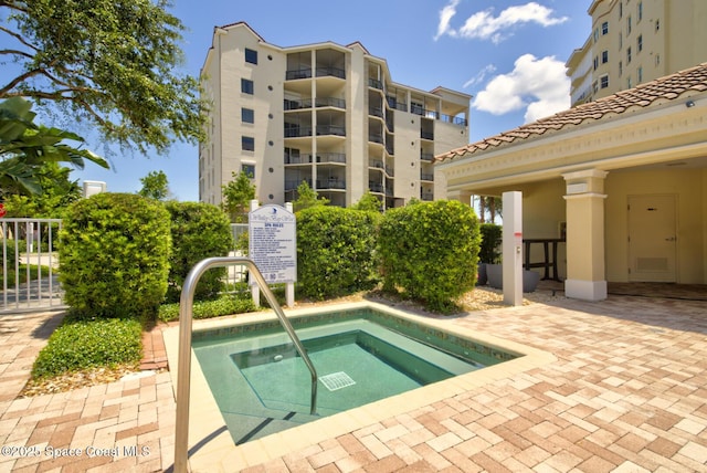 view of pool with a hot tub