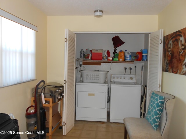 laundry area with washing machine and dryer and plenty of natural light